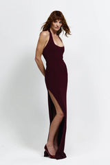 Myla Gown in Wine by Effie Kats, a deep scoop floor-length gown with open back, thigh-high split, and figure-hugging stretch fabric.