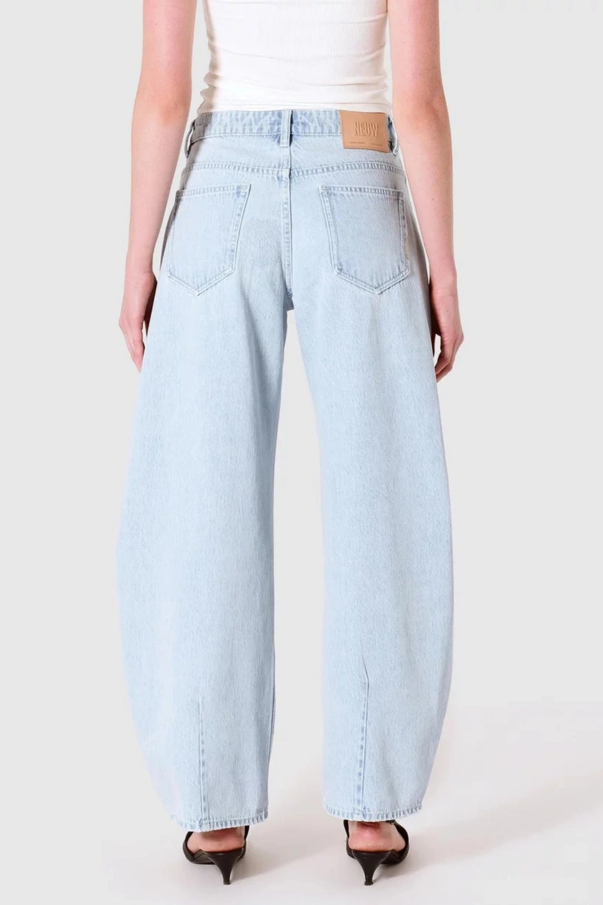 Nancy Barrel Adieu Jeans by Neuw Denim, mid-rise barrel leg denim in light vintage indigo. Perfect for laid-back, timeless outfits. 