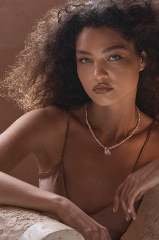 Narni Necklace by Amber Sceats, handcrafted in Italy with seashells and freshwater pearls plated in 24K gold for elegant coastal style.