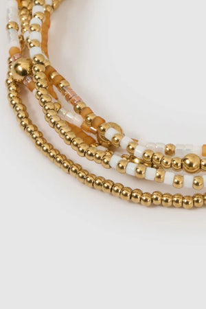 Nellie Bracelet Mango by Arms of Eve, vibrant beaded design with mango, white, and gold tones adding playful colour and chic sophistication.
