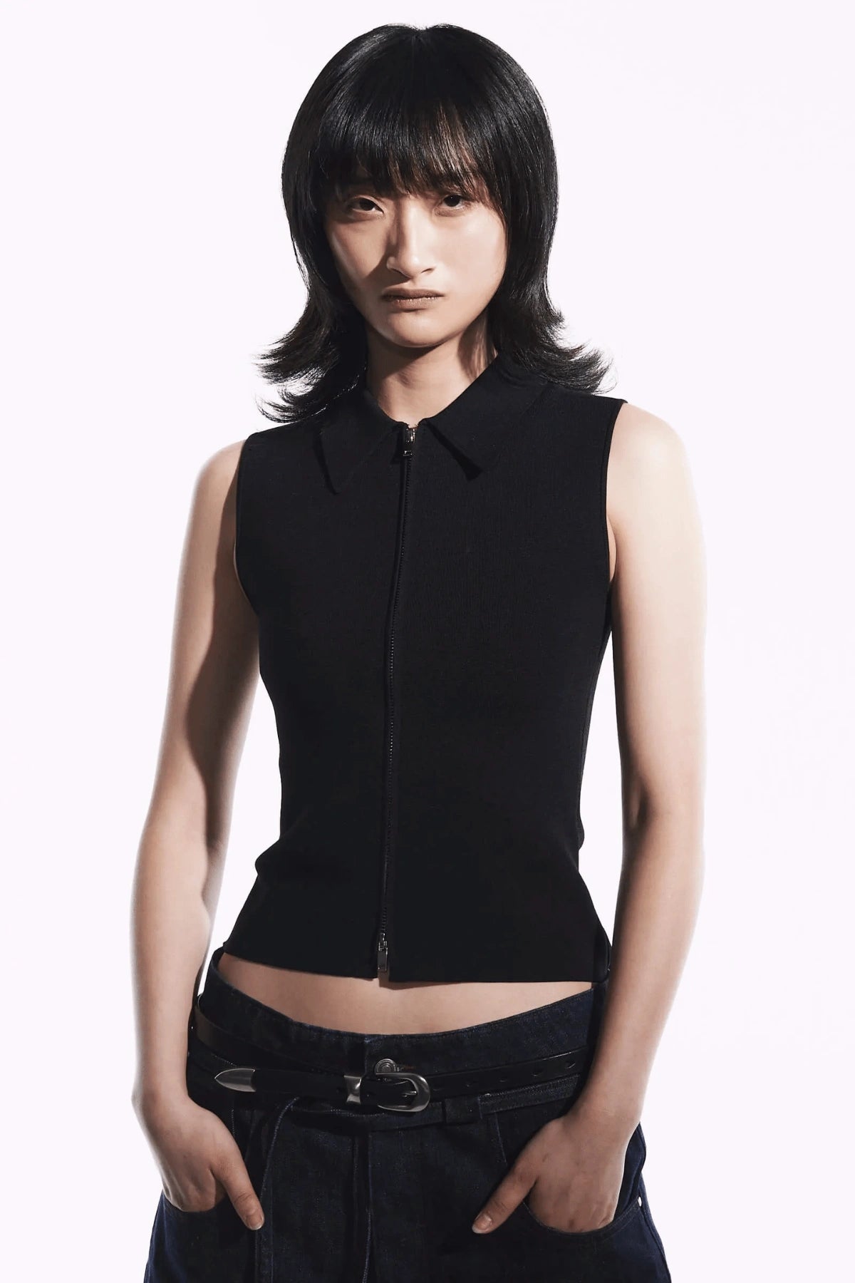Neuw Denim Suki Zip Top in Black, a slim sleeveless knit with collared neckline and double zip closure. Perfect for modern minimalist styling.