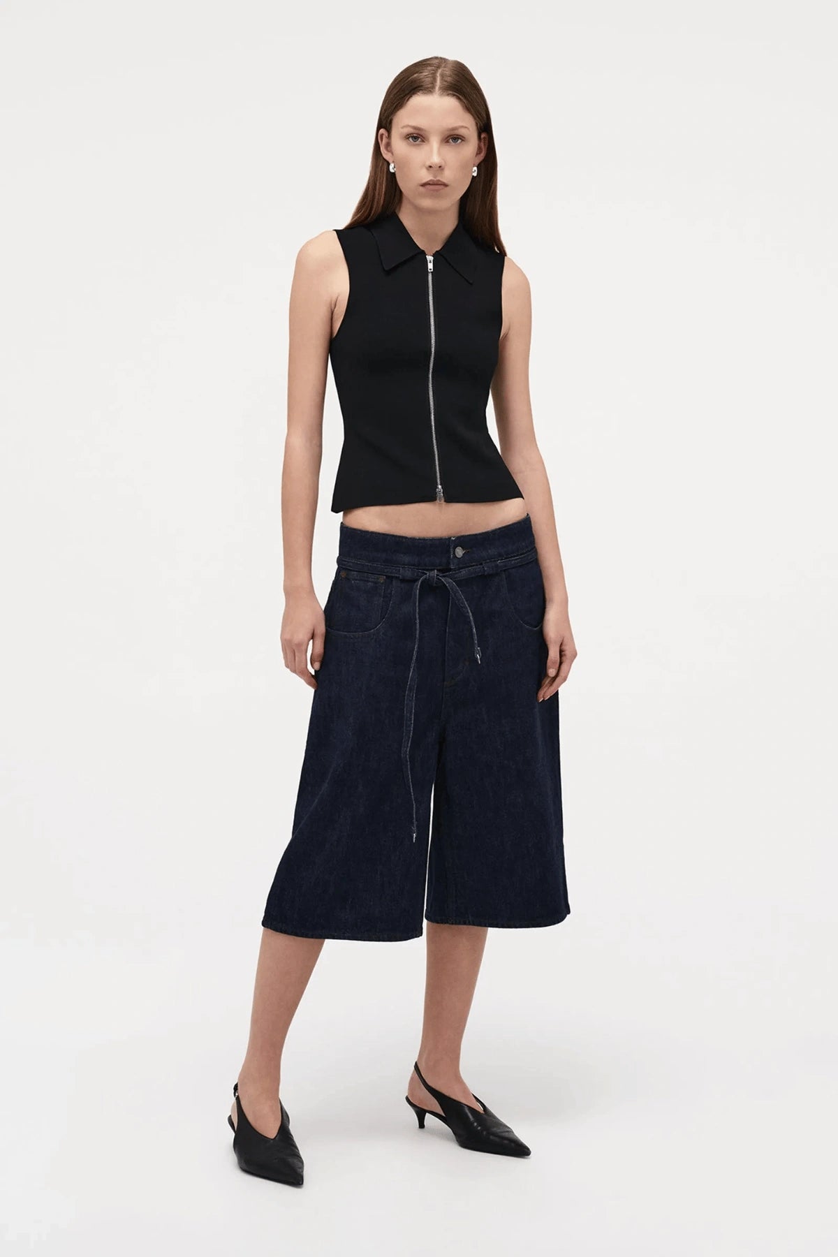 Neuw Denim Suki Zip Top in Black, a slim sleeveless knit with collared neckline and double zip closure. Perfect for modern minimalist styling.
