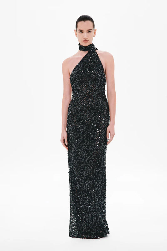 Nicolette Crochet Sequin Dress by Misha, a halter column gown in shimmering black sequins with draped sash detail for modern evening elegance.