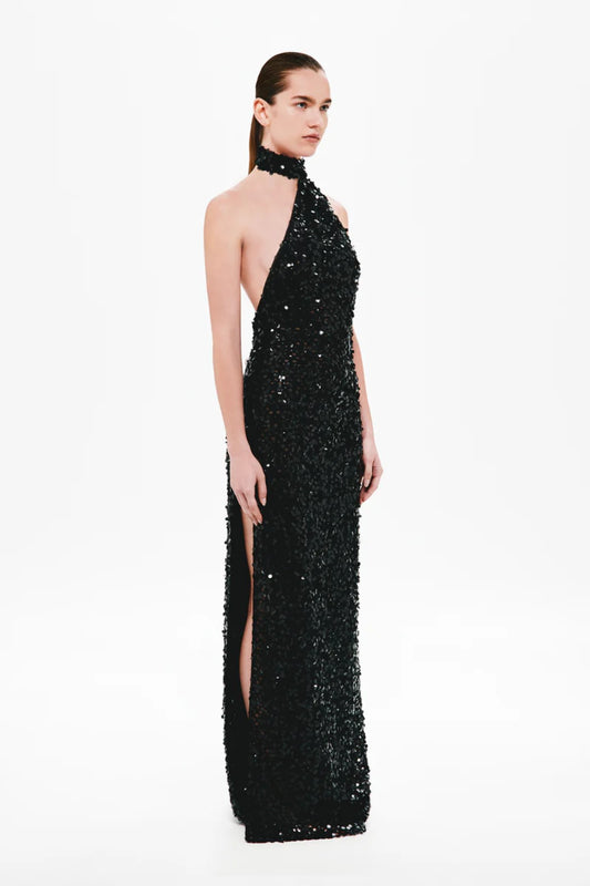 Nicolette Crochet Sequin Dress by Misha, a halter column gown in shimmering black sequins with draped sash detail for modern evening elegance.