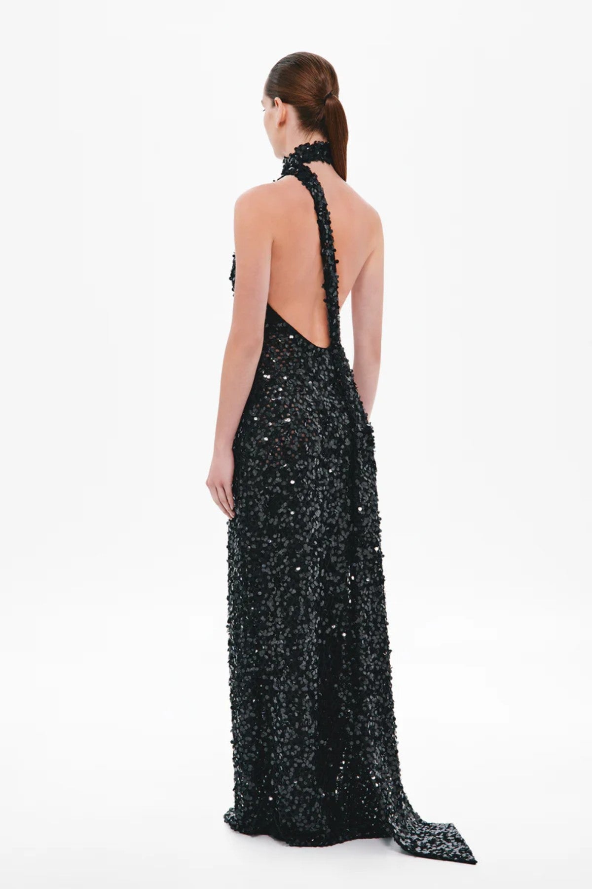 Nicolette Crochet Sequin Dress by Misha, a halter column gown in shimmering black sequins with draped sash detail for modern evening elegance.