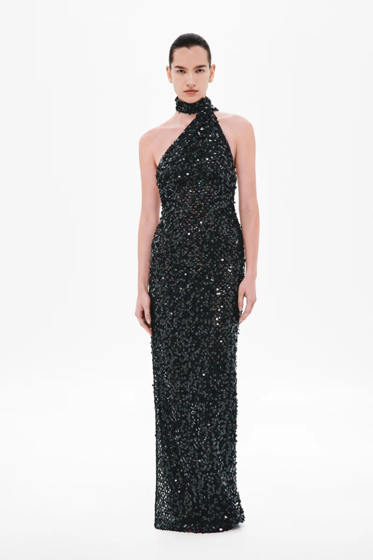 Nicolette Crochet Sequin Dress by Misha, a halter column gown in shimmering black sequins with draped sash detail for modern evening elegance.