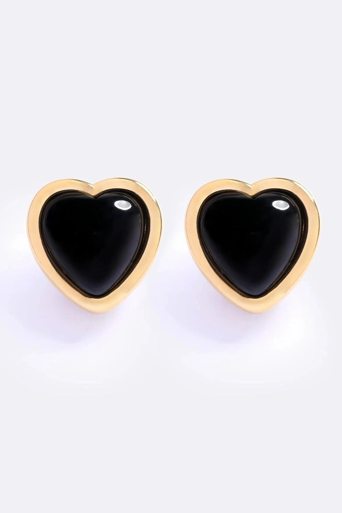Nightgasm Earrings in Black Glow by Emma Pills, heart-shaped enamel studs with 18k gold plating. Perfect for bold everyday looks.
