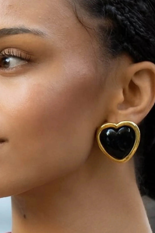 Nightgasm Earrings in Black Glow by Emma Pills, heart-shaped enamel studs with 18k gold plating. Perfect for bold everyday looks.
