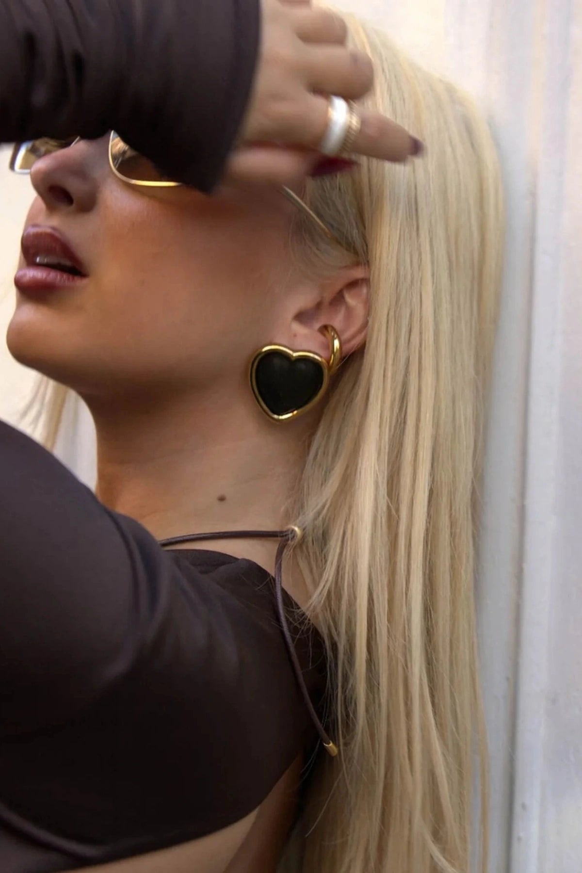 Nightgasm Earrings in Black Glow by Emma Pills, heart-shaped enamel studs with 18k gold plating. Perfect for bold everyday looks.

