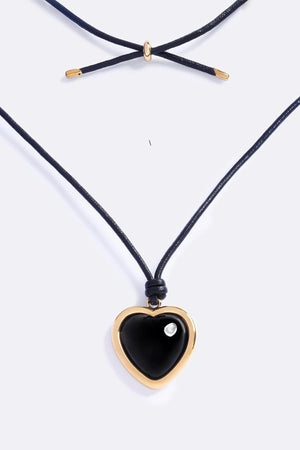 Nightgasm Necklace in Black Glow by Emma Pills, featuring a bold enamel heart pendant on adjustable leather rope. Ideal for standout layering.
