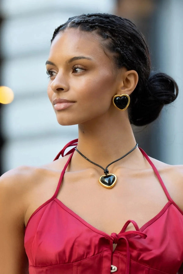 Nightgasm Necklace in Black Glow by Emma Pills, featuring a bold enamel heart pendant on adjustable leather rope. Ideal for standout layering.
