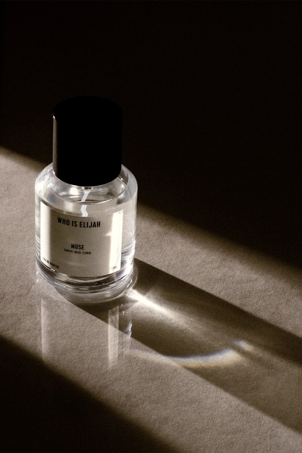 Muse 50ml by Who Is Elijah, a captivating unisex fragrance with tropical solar top notes, warm jasmine heart, and a musky, amberwood base.