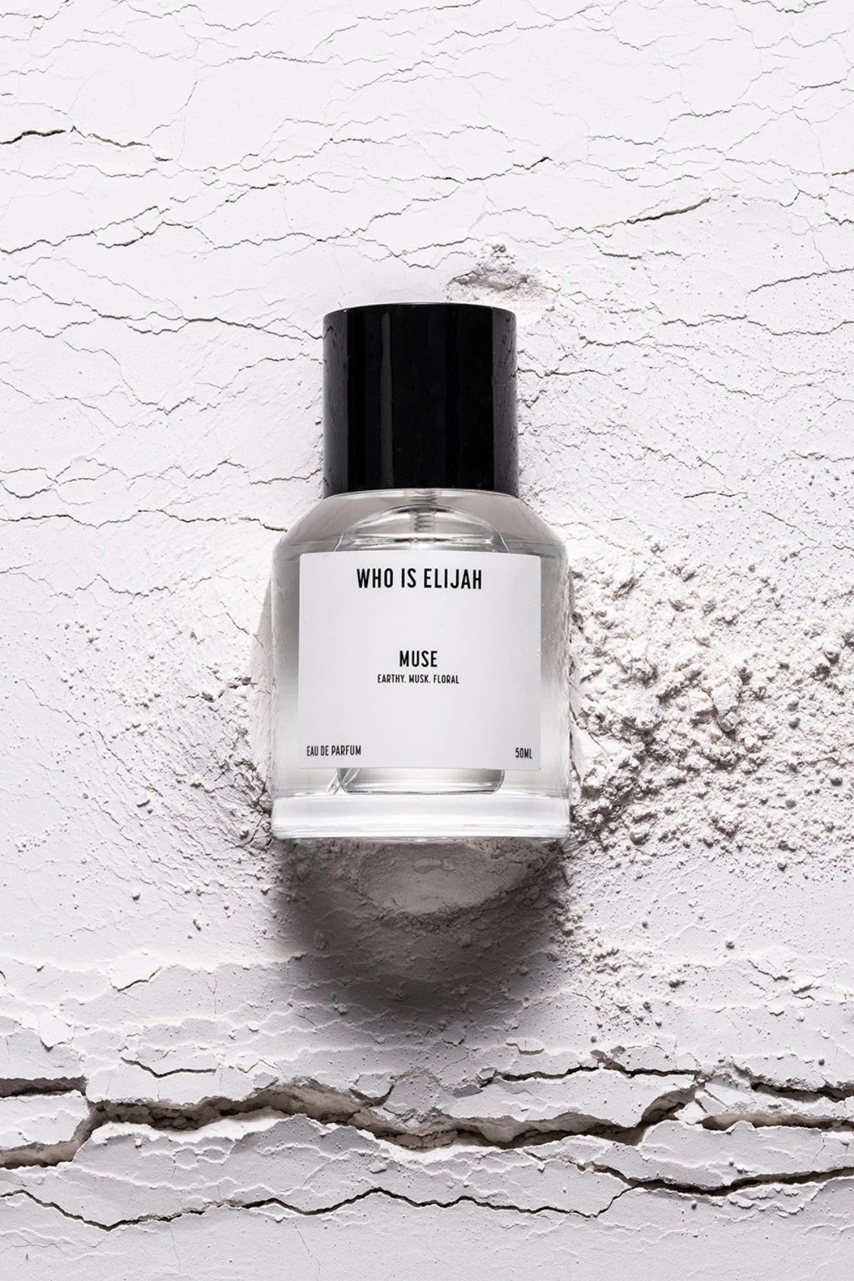 Muse 50ml by Who Is Elijah, a captivating unisex fragrance with tropical solar top notes, warm jasmine heart, and a musky, amberwood base.