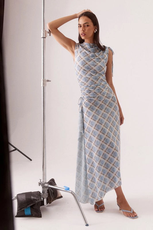 Novalyn Plaid Dress Check by Sovere, plaid midi dress with draped neckline and side tie detail. Perfect for elevated day to night styling.