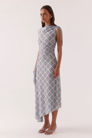 Novalyn Plaid Dress Check by Sovere, plaid midi dress with draped neckline and side tie detail. Perfect for elevated day to night styling.