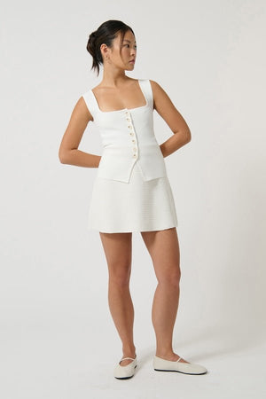 Margarita Top White by Onte, slim-fitting Milano knit tank with wide straps and square neckline, featuring tonal buttons, perfect for trendy viral chic and versatile layering.
