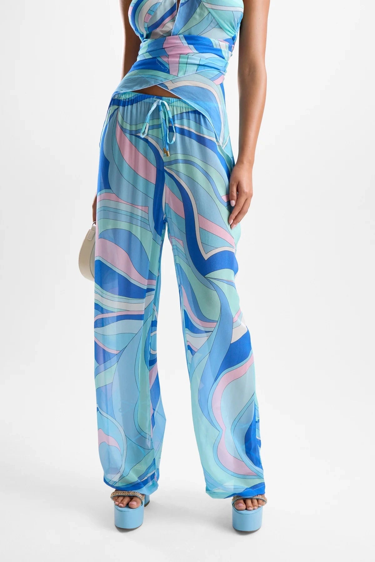 ‘Oasis’ Pants Dolce Blue by Cin Cin – relaxed viscose pants with elasticated waist and beaded drawstrings in a blue swirl print.
