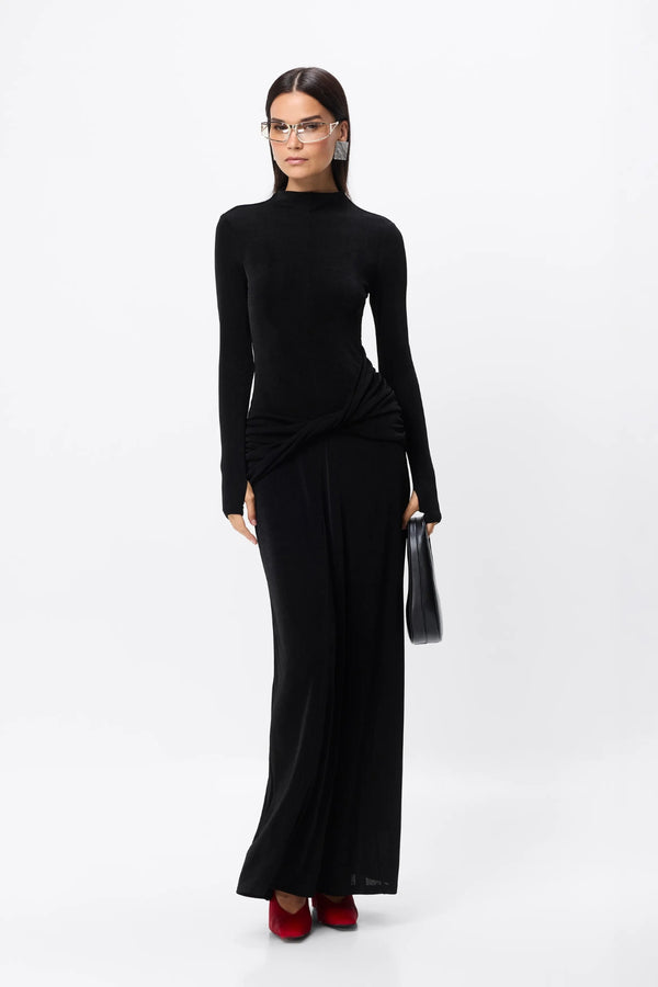 Ode Maxi Dress Black by Mossman – lustrous stretch jersey maxi dress with asymmetric twist waist and long sleeves.