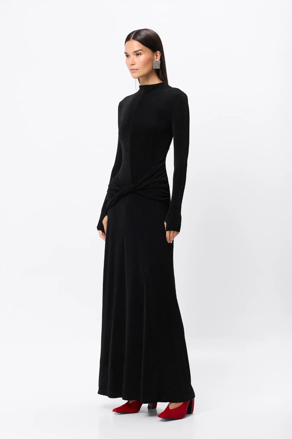 Ode Maxi Dress Black by Mossman – lustrous stretch jersey maxi dress with asymmetric twist waist and long sleeves.