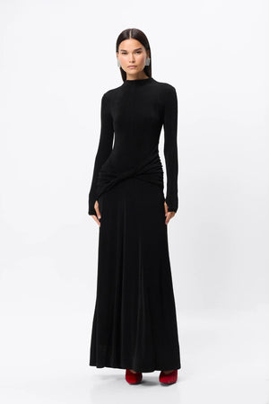 Ode Maxi Dress Black by Mossman – lustrous stretch jersey maxi dress with asymmetric twist waist and long sleeves.