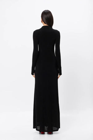 Ode Maxi Dress Black by Mossman – lustrous stretch jersey maxi dress with asymmetric twist waist and long sleeves.