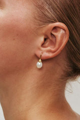 Odette Pearl Earrings by Heaven Mayhem – gold hook earrings with luminous pearl drops, perfect for timeless everyday elegance.