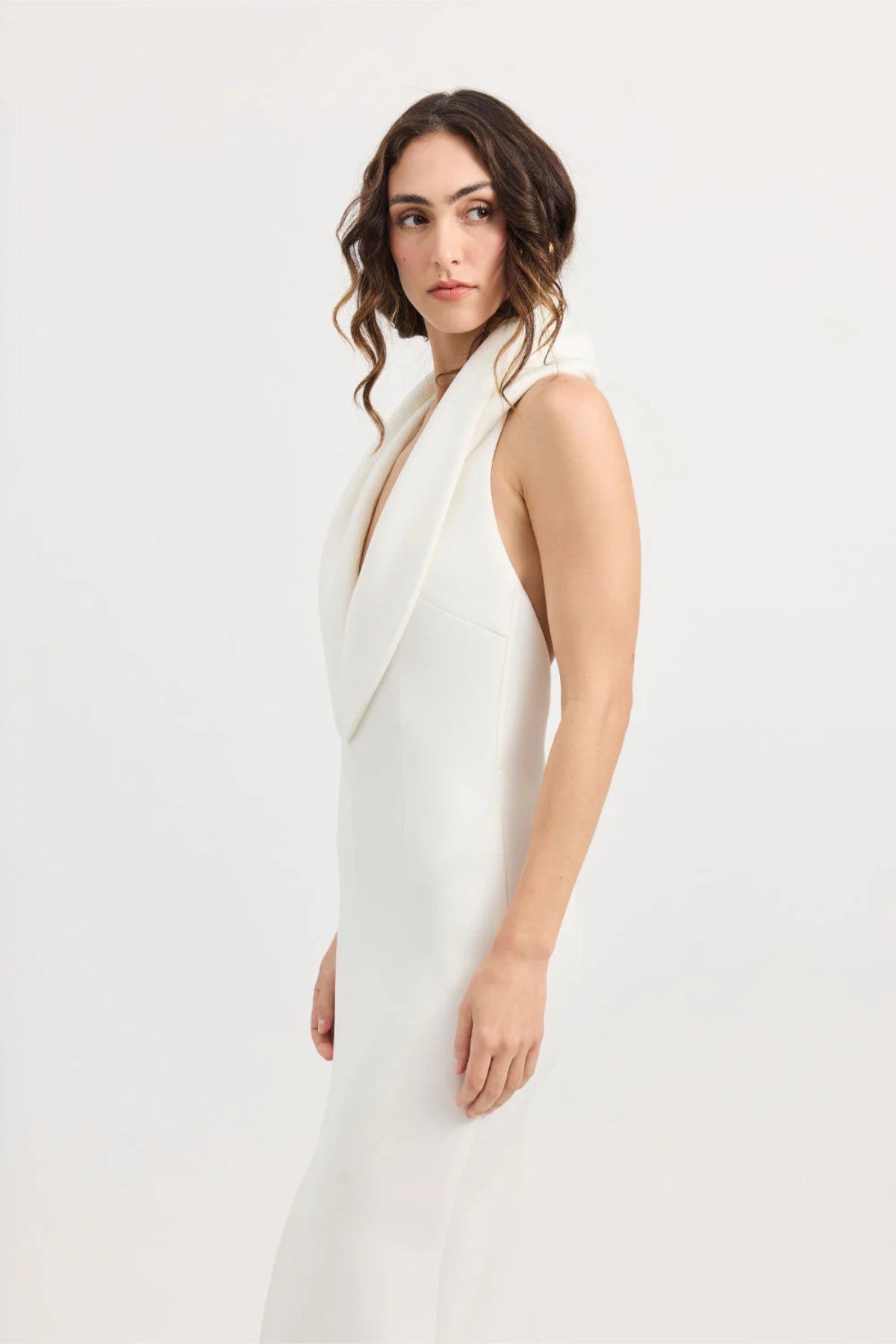 Odora Dress in Ivory by Tojhà, a sculpted halter maxi in lightweight scuba with plunging neckline, front split, and low back for modern allure.