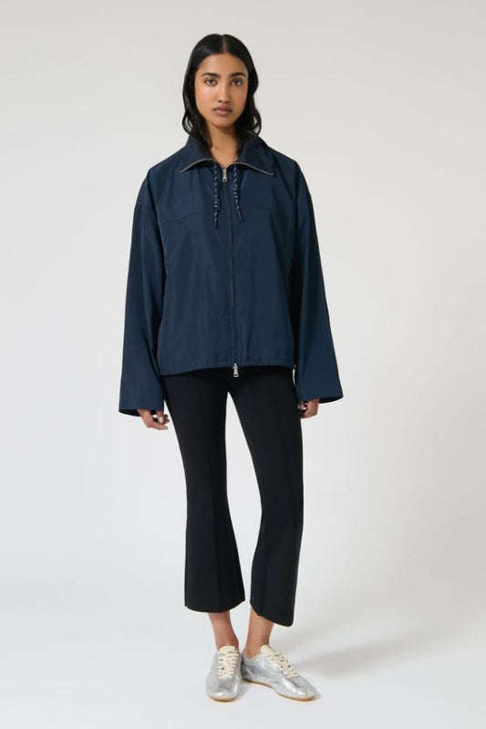 Onte Adela Windbreaker in Navy, oversized water-resistant jacket with funnel neck, paracord drawstrings, and two-ended silver zips.