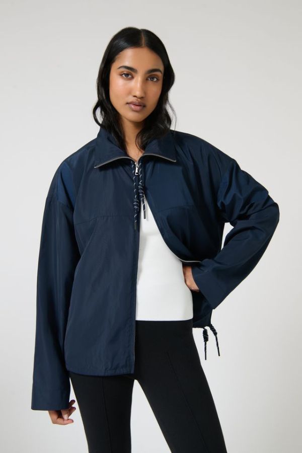 Onte Adela Windbreaker in Navy, oversized water-resistant jacket with funnel neck, paracord drawstrings, and two-ended silver zips.