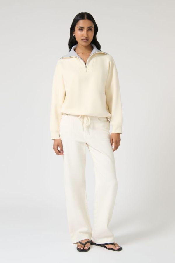Onte Nerea Sweater in Ivory/Grey, soufflé knit with two-tone collar, half zip, silver hardware, and drawstring waist for versatility.