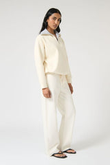 Onte Nerea Sweater in Ivory/Grey, soufflé knit with two-tone collar, half zip, silver hardware, and drawstring waist for versatility.