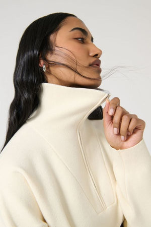Onte Nerea Sweater in Ivory/Grey, soufflé knit with two-tone collar, half zip, silver hardware, and drawstring waist for versatility.
