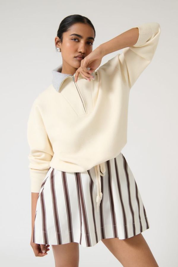 Onte Nerea Sweater in Ivory/Grey, soufflé knit with two-tone collar, half zip, silver hardware, and drawstring waist for versatility.