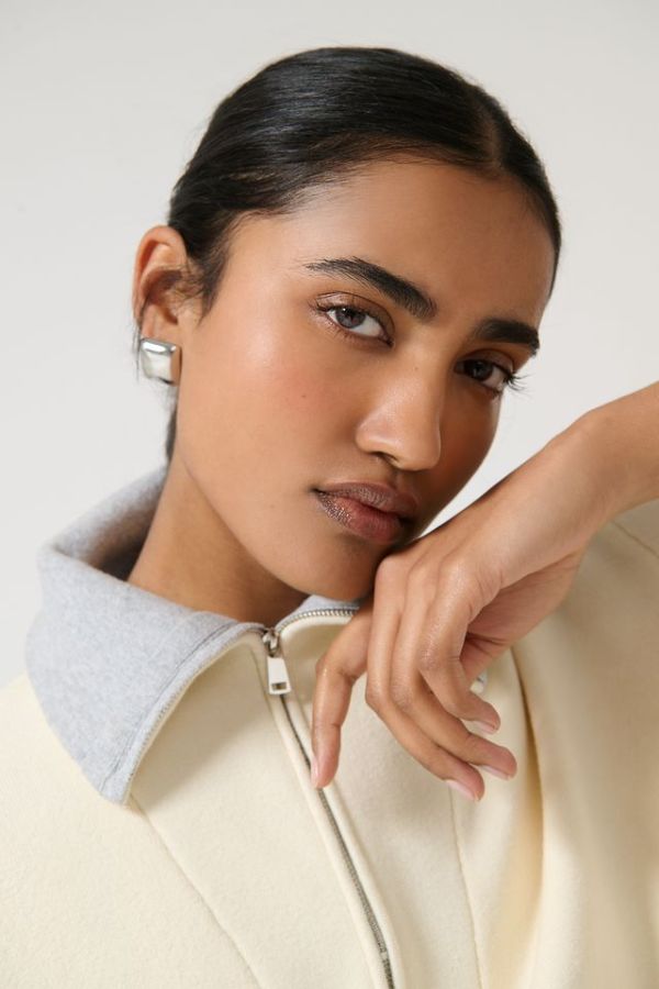 Onte Nerea Sweater in Ivory/Grey, soufflé knit with two-tone collar, half zip, silver hardware, and drawstring waist for versatility.