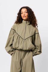 Overturn Jacket Fern by Mossman - lightweight technical jacket with funnel neckline and voluminous sleeves, perfect for modern elevated layering.