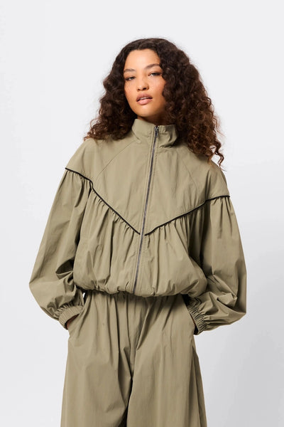 Overturn Jacket Fern by Mossman - lightweight technical jacket with funnel neckline and voluminous sleeves, perfect for modern elevated layering.