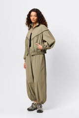 Overturn Jacket Fern by Mossman - lightweight technical jacket with funnel neckline and voluminous sleeves, perfect for modern elevated layering.