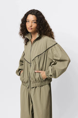 Overturn Jacket Fern by Mossman - lightweight technical jacket with funnel neckline and voluminous sleeves, perfect for modern elevated layering.