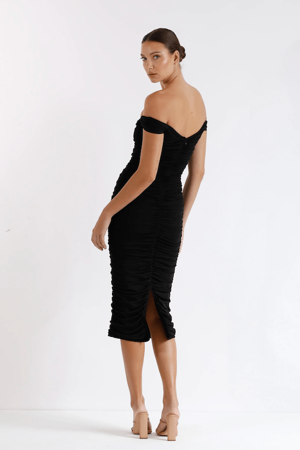 New Horizon Tapered Midi Black by Pasduchas – A trendy off-shoulder midi with ruched stretch mesh, sheer straps, and a flattering fitted silhouette. Perfect for elegant evenings and stylish occasions.
