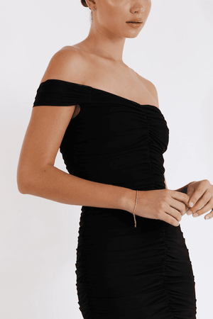 New Horizon Tapered Midi Black by Pasduchas – A trendy off-shoulder midi with ruched stretch mesh, sheer straps, and a flattering fitted silhouette. Perfect for elegant evenings and stylish occasions.