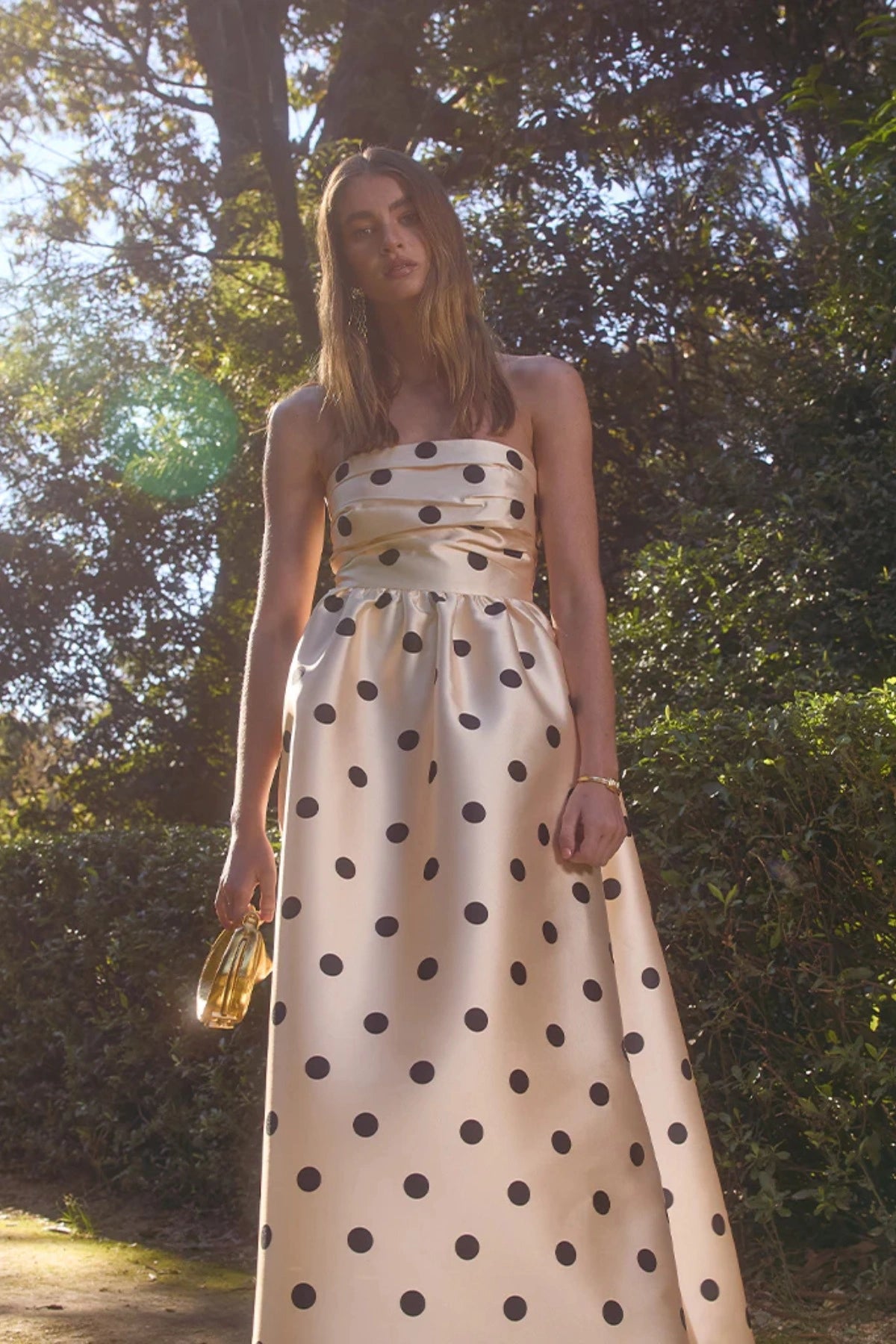 Pasduchas Dottie Strapless Midi in cream with black polka dots, strapless bodice with tucks, full flared midi skirt, and side pockets.