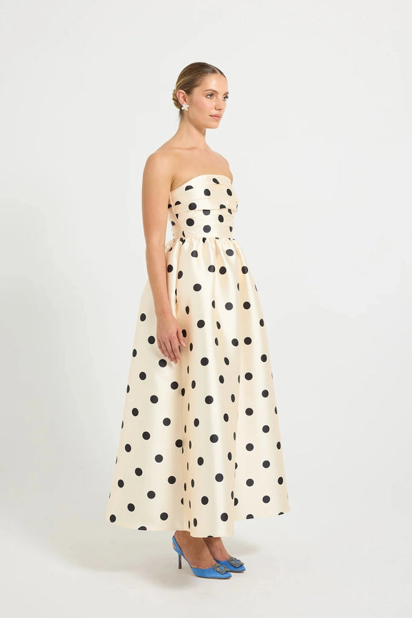 Pasduchas Dottie Strapless Midi in cream with black polka dots, strapless bodice with tucks, full flared midi skirt, and side pockets. 
