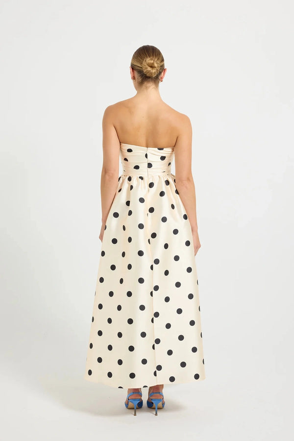 Pasduchas Dottie Strapless Midi in cream with black polka dots, strapless bodice with tucks, full flared midi skirt, and side pockets.