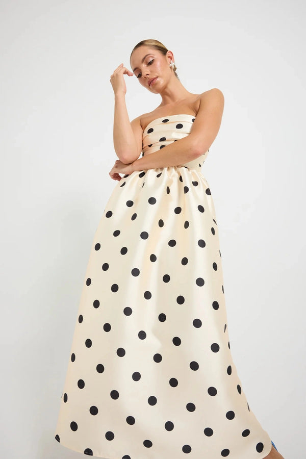 Pasduchas Dottie Strapless Midi in cream with black polka dots, strapless bodice with tucks, full flared midi skirt, and side pockets.