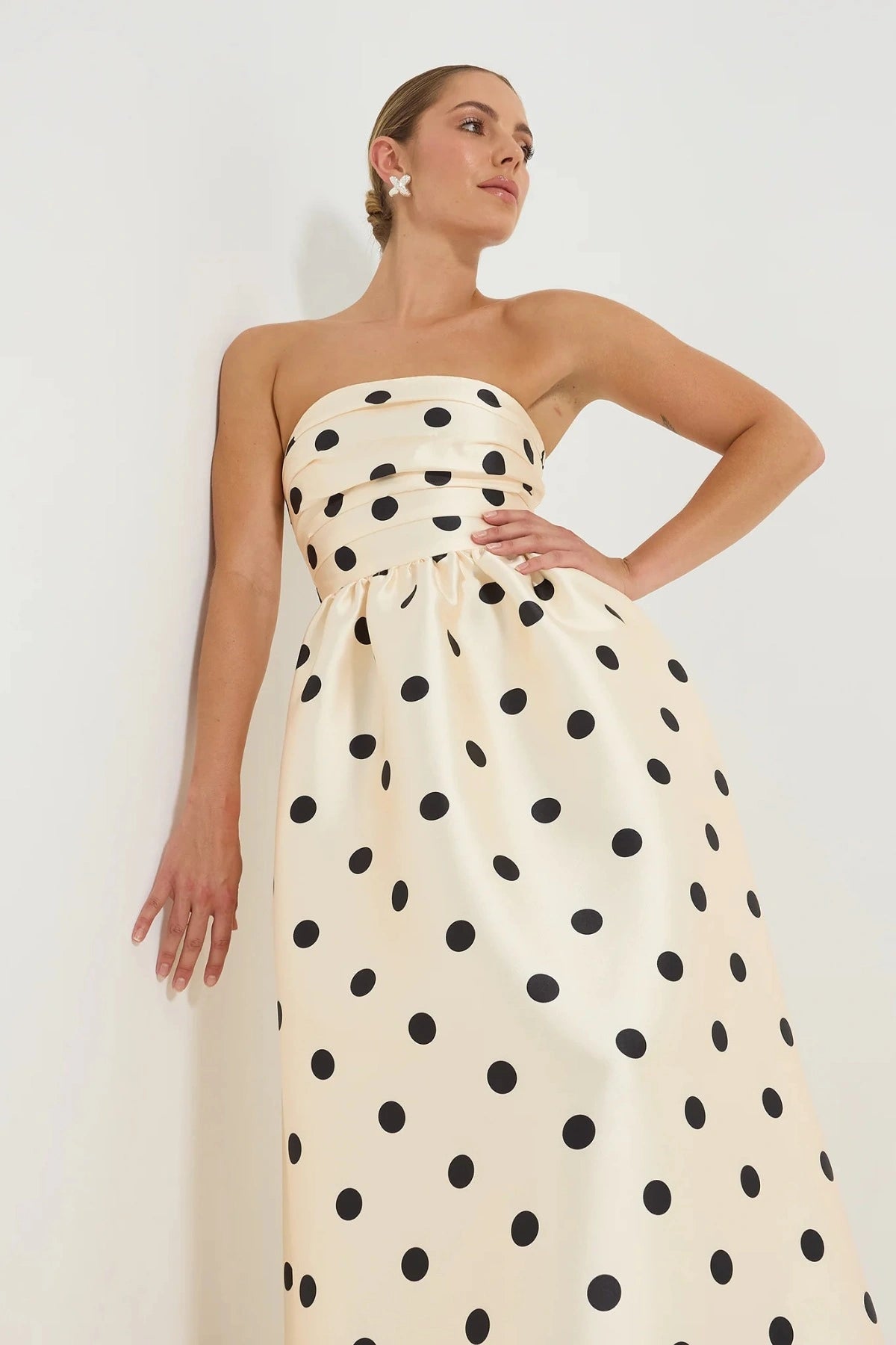 Pasduchas Dottie Strapless Midi in cream with black polka dots, strapless bodice with tucks, full flared midi skirt, and side pockets.