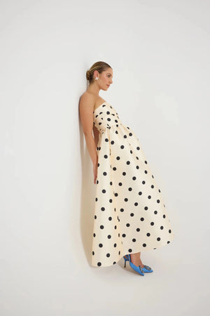 Pasduchas Dottie Strapless Midi in cream with black polka dots, strapless bodice with tucks, full flared midi skirt, and side pockets.