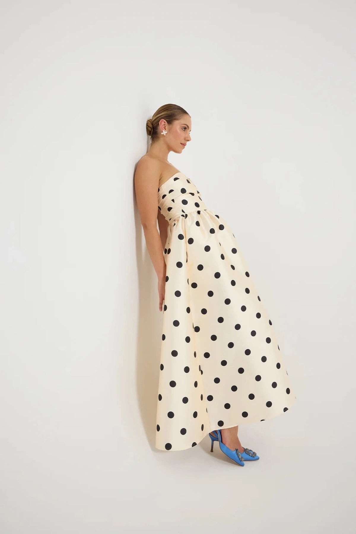 Pasduchas Dottie Strapless Midi in cream with black polka dots, strapless bodice with tucks, full flared midi skirt, and side pockets.