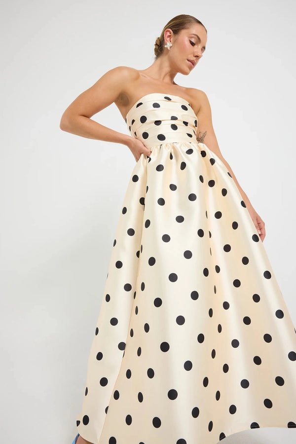 Pasduchas Dottie Strapless Midi in cream with black polka dots, strapless bodice with tucks, full flared midi skirt, and side pockets.