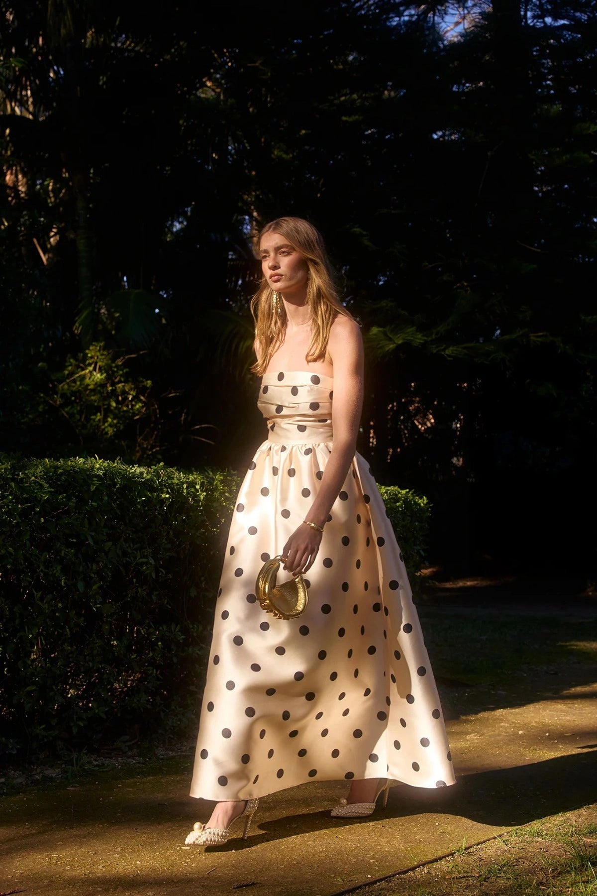 Pasduchas Dottie Strapless Midi in cream with black polka dots, strapless bodice with tucks, full flared midi skirt, and side pockets.
