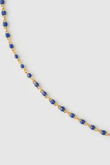 Peggy Necklace Blueberry by Arms of Eve, a dainty gold chain with blueberry enamel beads, perfect for summer layering and open-back looks.